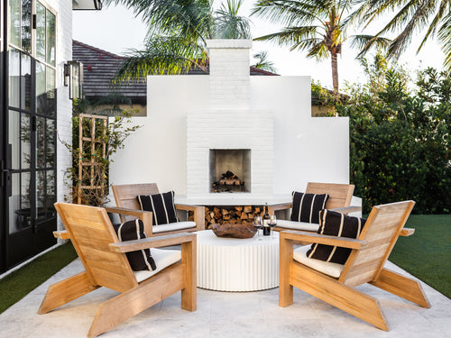 White outdoor fireplace with four wooden chairs around a table - View products for your outdoor space