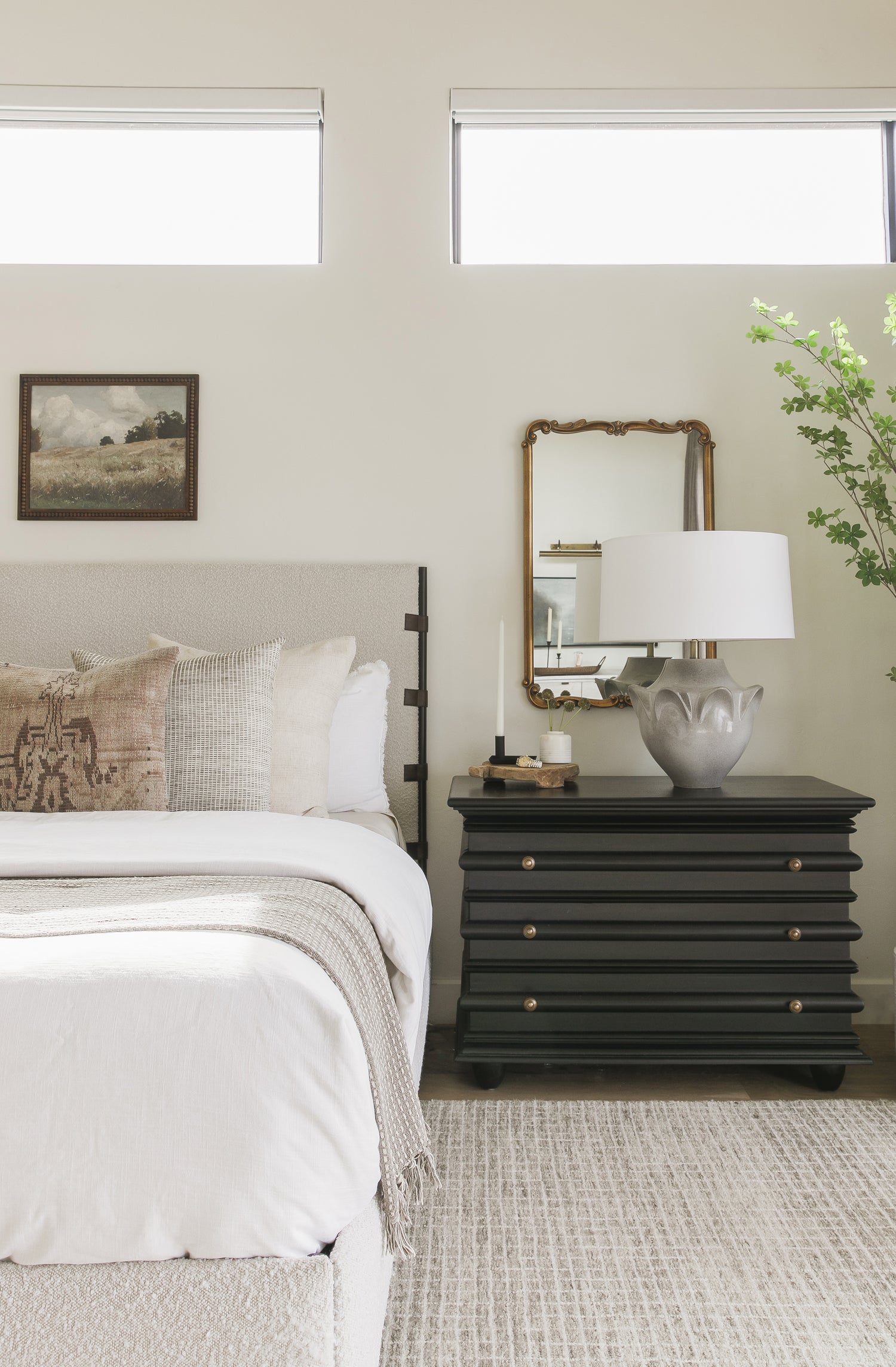 Bed and nightstand with several coordinating pillows arranged on the bed - View our designer guide to pillow collections